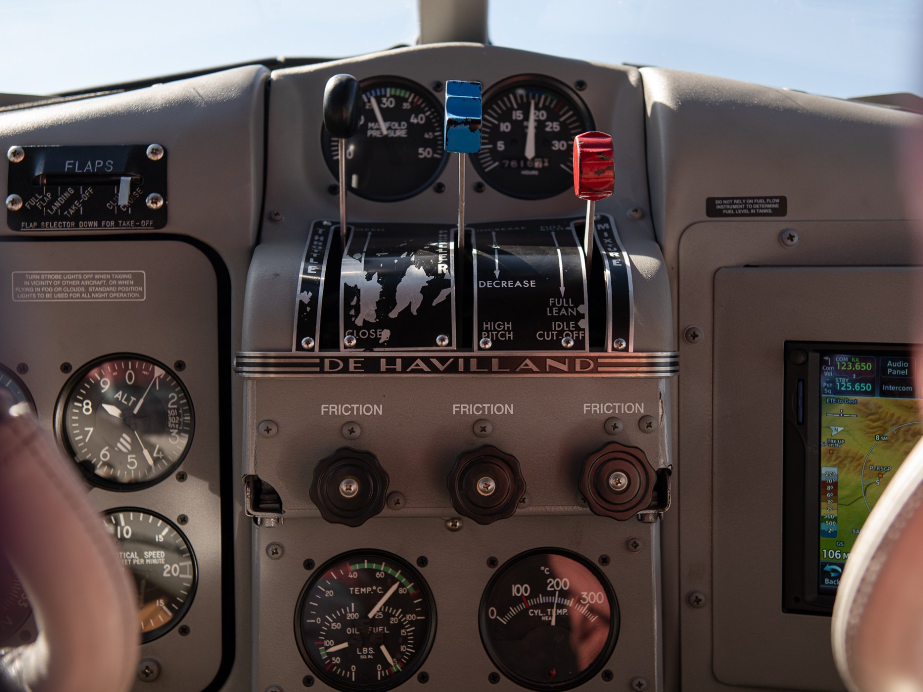 Close-up of a DH Beaver cockpit dashboard with various instruments and controls.