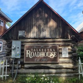 Wooden building labeled 'Talkeetna Roadhouse Est. 1944'
