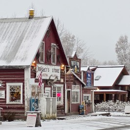 Snow-covered rustic storefronts in Talkeetna Main Street during Winter