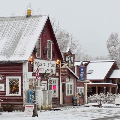 Snow-covered rustic storefronts in Talkeetna Main Street during Winter