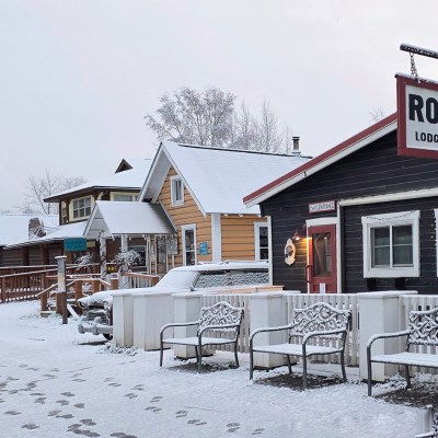 Snowy street with Roadhouse sign and snow-covered benches in main street Talkeetna Alaska