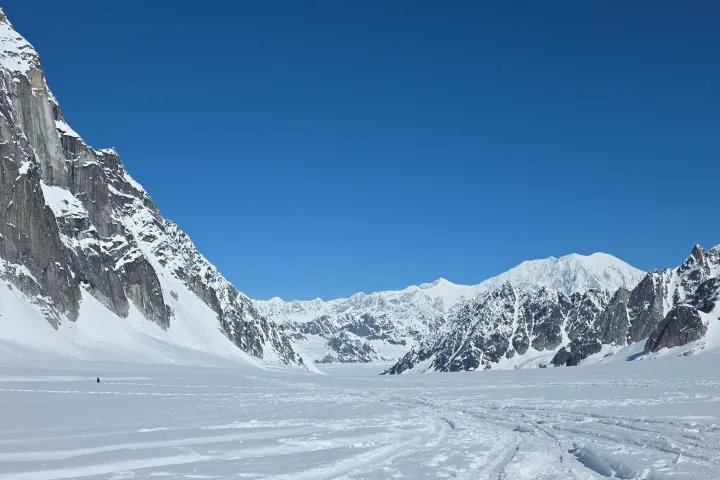 Snow-covered mountains under a clear blue sky.