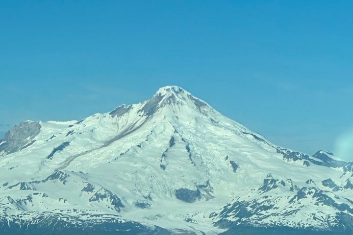 Snow-covered mountain peak under a clear blue sky.